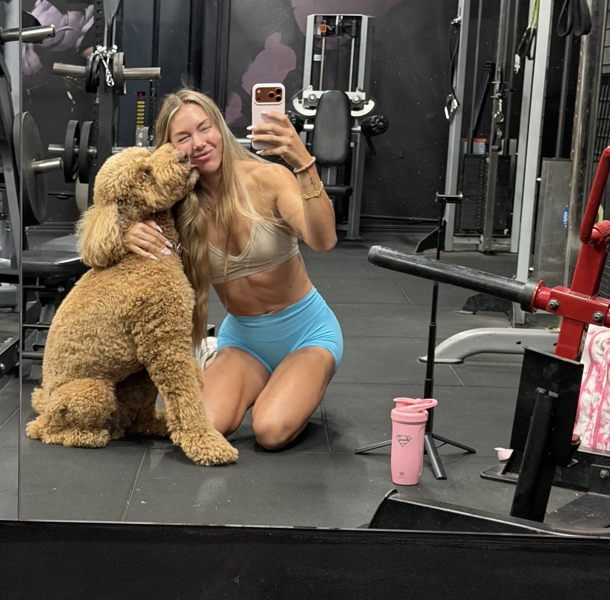 Thea Berntsen in the gym with her dog